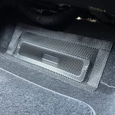 Velcro-attached vent cover under front seat of Tesla Model Y Juniper