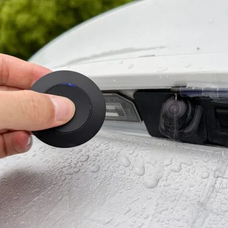 Remote controlled backup camera cleaner with wireless remote operation