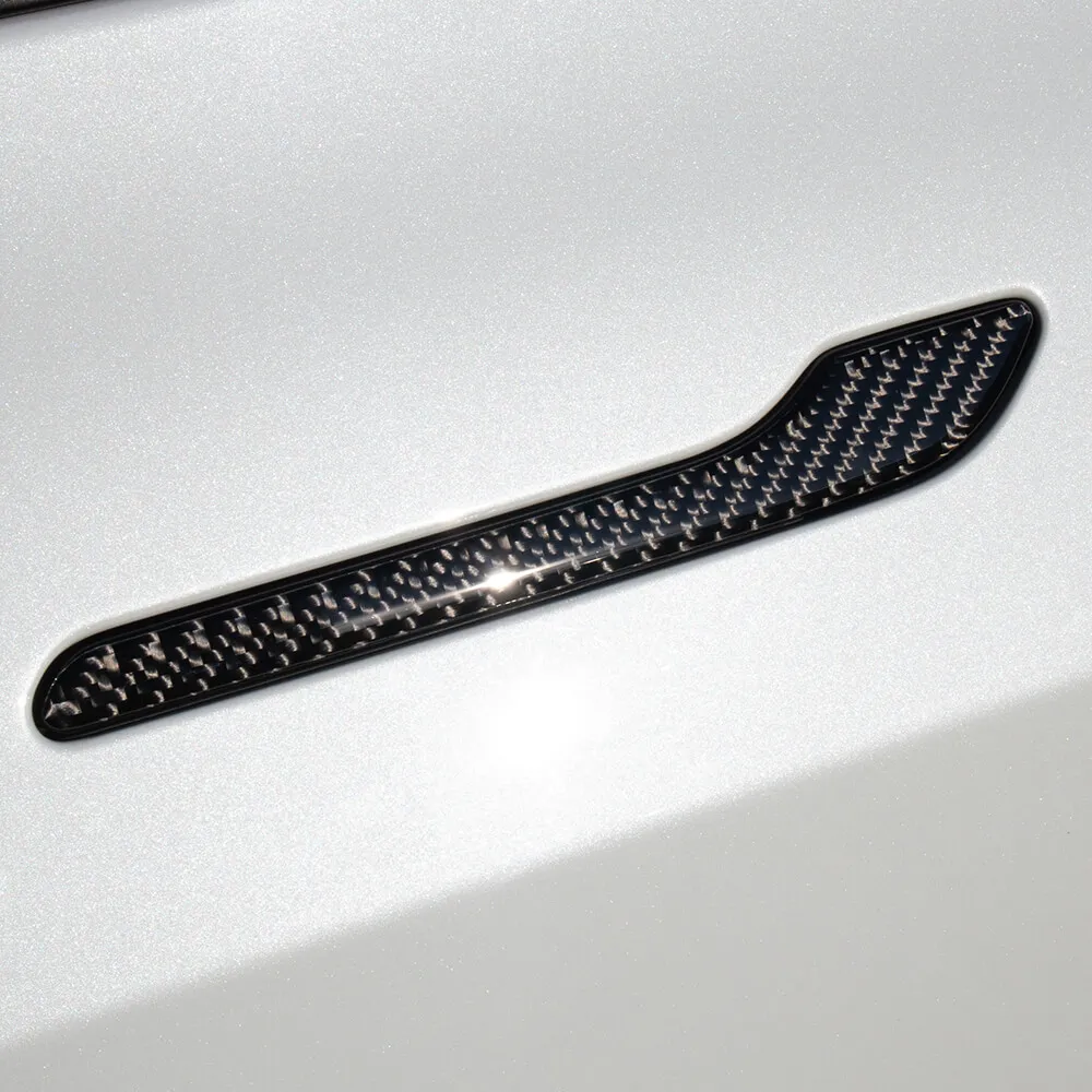 Black carbon fiber door handle trim installed on Tesla Model Y